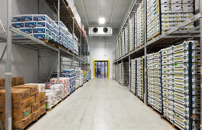 Chilled storage aisle with refrigeration units and palletised goods