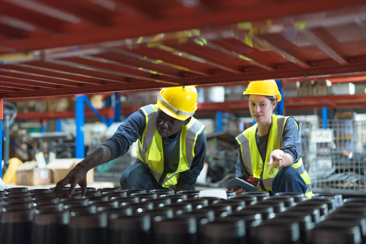 Logistics crew working alongside a conveyor line in a distribution facility