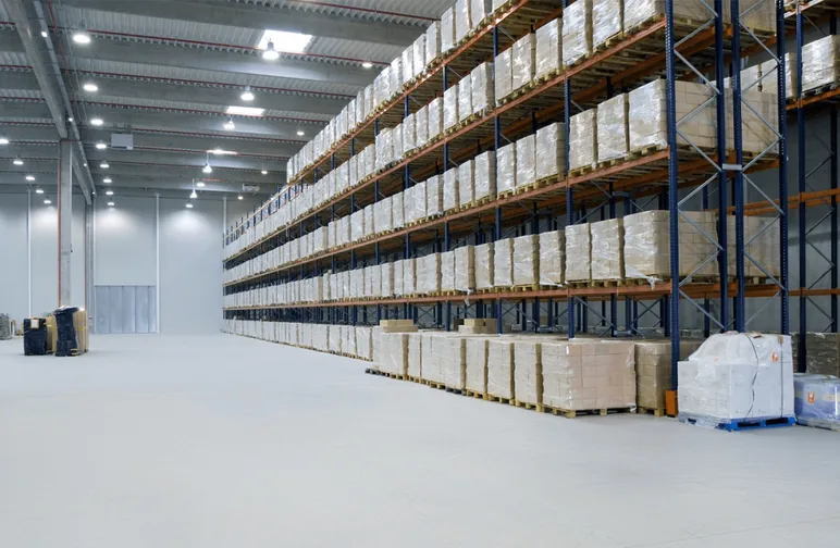 Wide high-bay warehouse with pallet racking running the length of the building